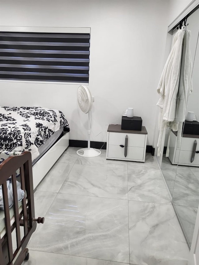 bedroom with marble finish floor and baseboards