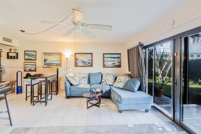 living area with light tile patterned flooring, visible vents, and a ceiling fan