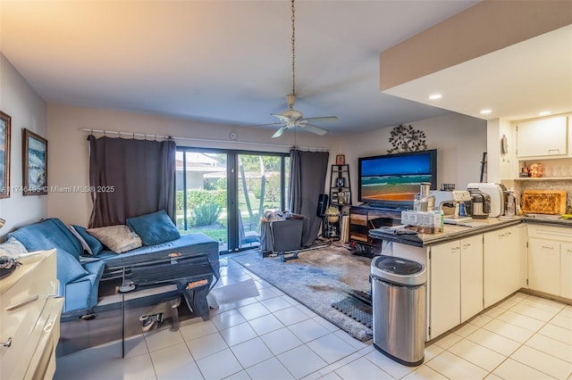 living room featuring ceiling fan and light tile patterned flooring