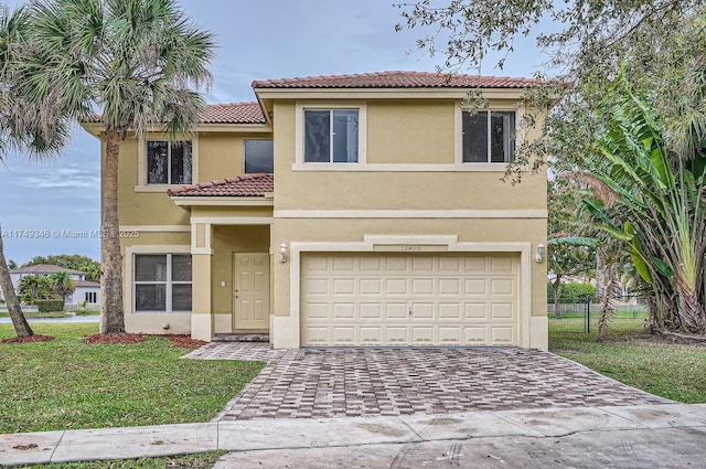 view of front of home with stucco siding, a tiled roof, an attached garage, decorative driveway, and a front yard