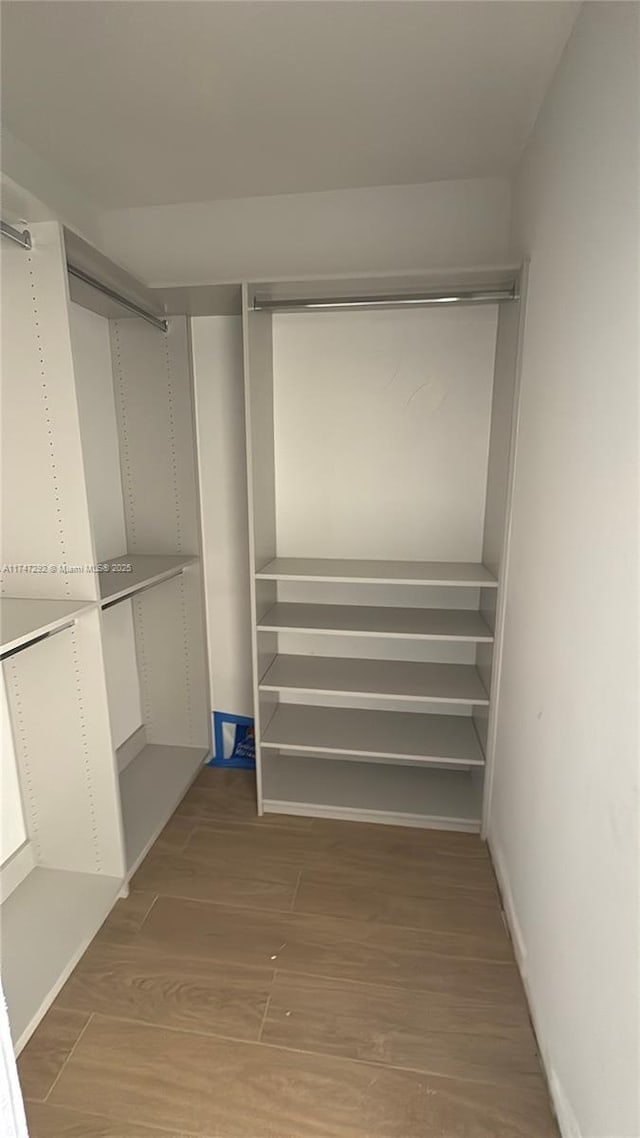 spacious closet featuring wood finished floors