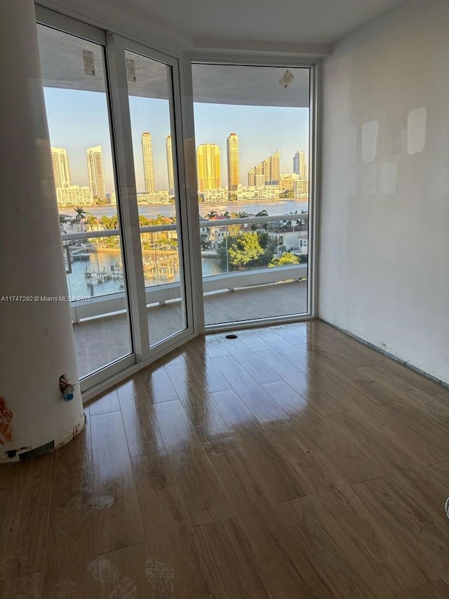 7000 Island Blvd Unit 905, Aventura, FL 33160 - unfurnished room featuring a city view, a wall of windows, and wood finished floors