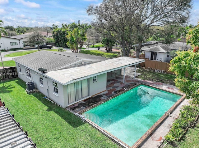 view of swimming pool with central AC, a lawn, a patio, and a fenced backyard