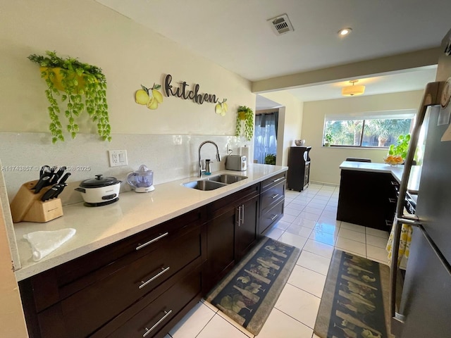 8415 SW 107th Ave Unit 363W, Miami, FL 33173 - kitchen with light countertops, light tile patterned floors, freestanding refrigerator, dark brown cabinets, and recessed lighting