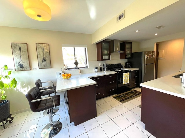 8415 SW 107th Ave Unit 363W, Miami, FL 33173 - kitchen featuring black range with electric cooktop, wall chimney range hood, freestanding refrigerator, and light countertops