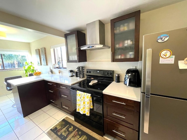 8415 SW 107th Ave Unit 363W, Miami, FL 33173 - kitchen with freestanding refrigerator, black / electric stove, exhaust hood, a peninsula, and light countertops