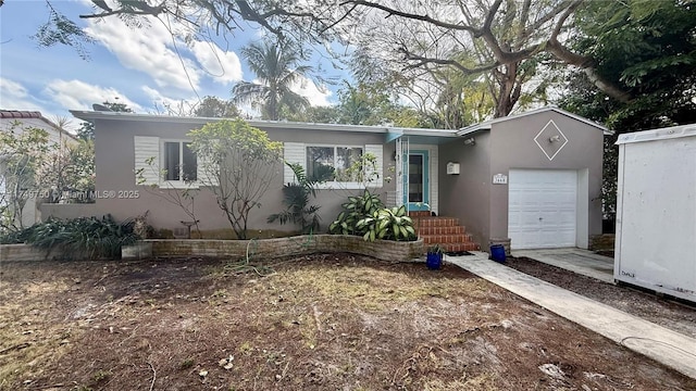 view of front of property featuring an attached garage and stucco siding