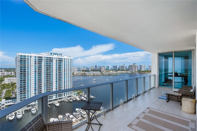 balcony with a view of city and a water view