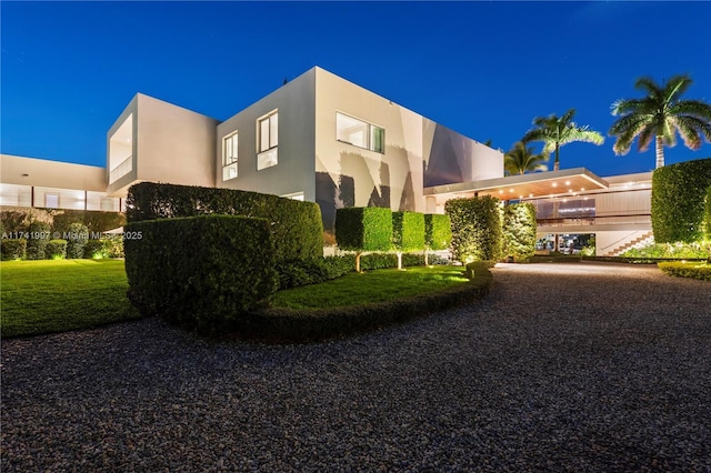 exterior space with a yard and stucco siding