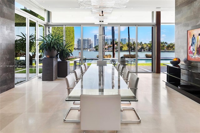 interior space with a view of city, a wall of windows, and a water view