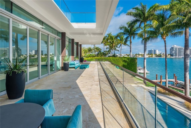 exterior space with a water view, a view of city, and a patio