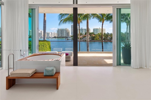 entryway featuring a water view and a city view