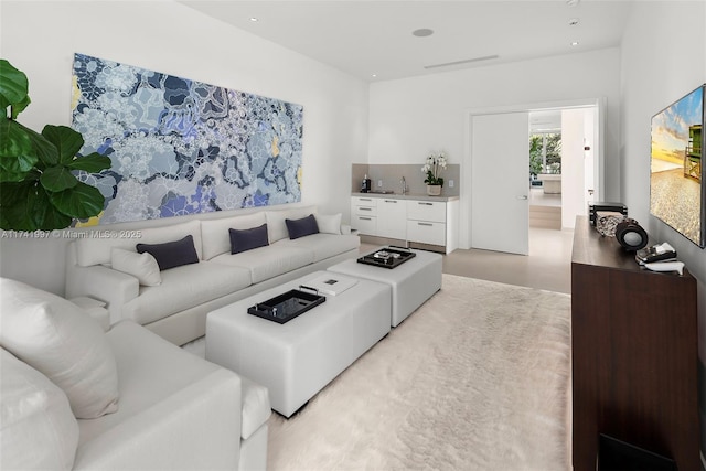 living room with concrete flooring and recessed lighting