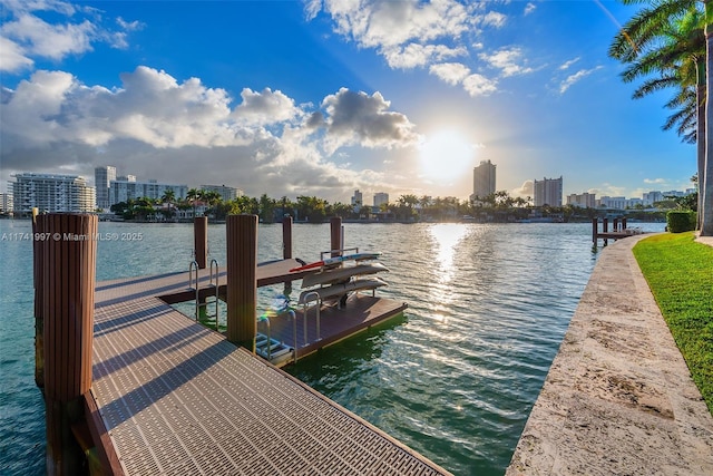 view of dock featuring a city view and a water view