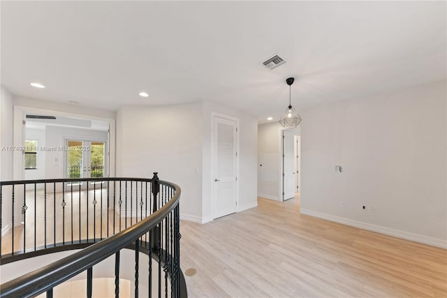 corridor featuring recessed lighting, visible vents, an upstairs landing, light wood-type flooring, and baseboards