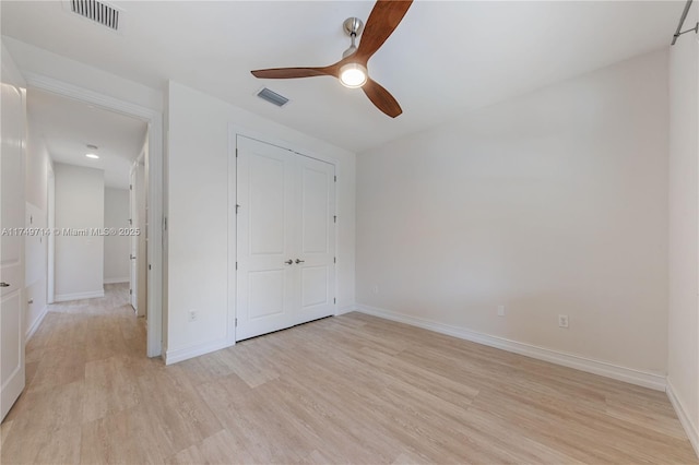 unfurnished bedroom featuring light wood-style flooring, visible vents, and baseboards