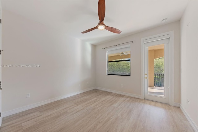 unfurnished room with ceiling fan, light wood-type flooring, and baseboards