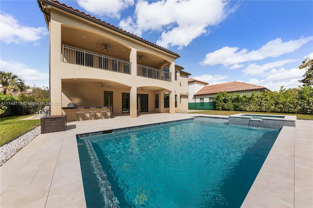 back of property featuring outdoor dry bar, ceiling fan, a patio area, and fence