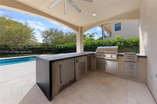 view of patio with an outdoor kitchen, a fenced in pool, ceiling fan, a grill, and fence