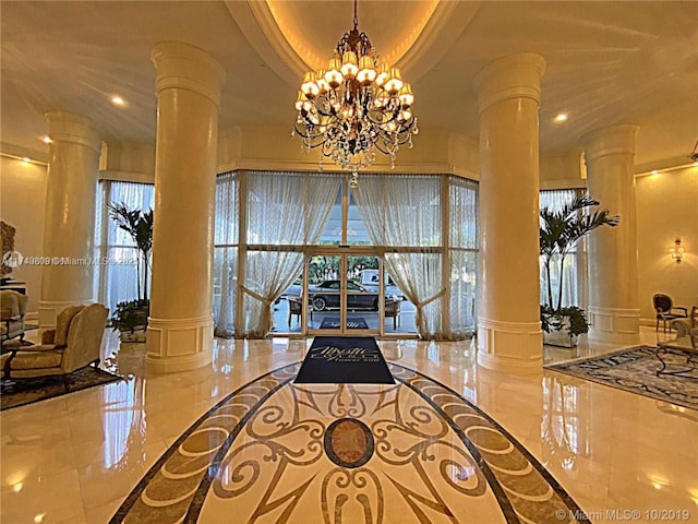 3530 Mystic Pointe Dr Unit 2303, Aventura, FL 33180 - foyer entrance with a decorative wall, decorative columns, ornamental molding, plenty of natural light, and wainscoting