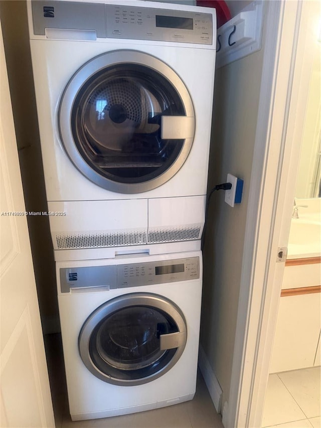 3530 Mystic Pointe Dr Unit 2303, Aventura, FL 33180 - clothes washing area featuring stacked washing machine and dryer and tile patterned floors