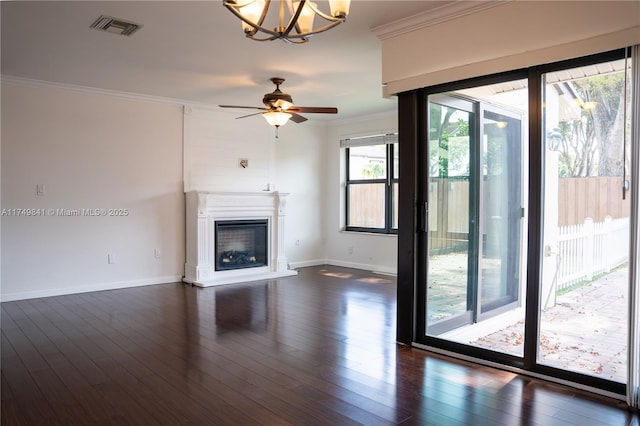 unfurnished living room with baseboards, visible vents, a glass covered fireplace, ornamental molding, and dark wood-type flooring