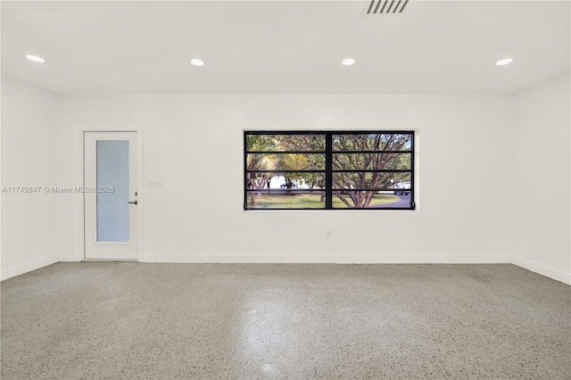 empty room featuring recessed lighting, visible vents, and baseboards