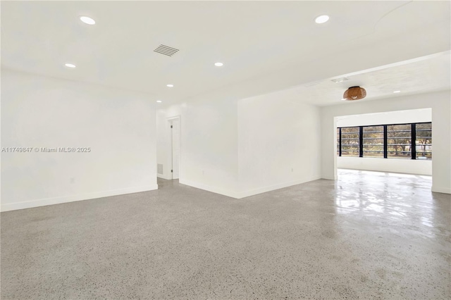 unfurnished room featuring speckled floor, recessed lighting, visible vents, and baseboards