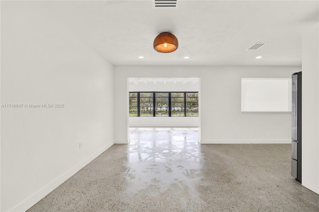 empty room with visible vents, recessed lighting, and baseboards