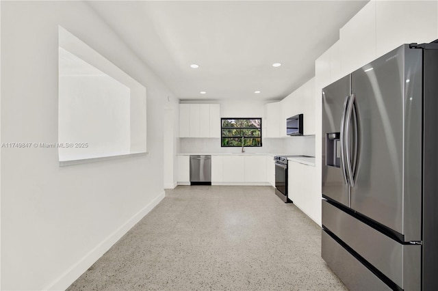 kitchen featuring recessed lighting, stainless steel appliances, light countertops, white cabinets, and modern cabinets