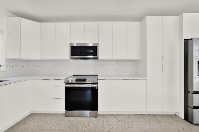 kitchen with white cabinetry, appliances with stainless steel finishes, and light countertops