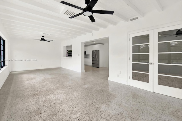 spare room with visible vents, beamed ceiling, french doors, and speckled floor