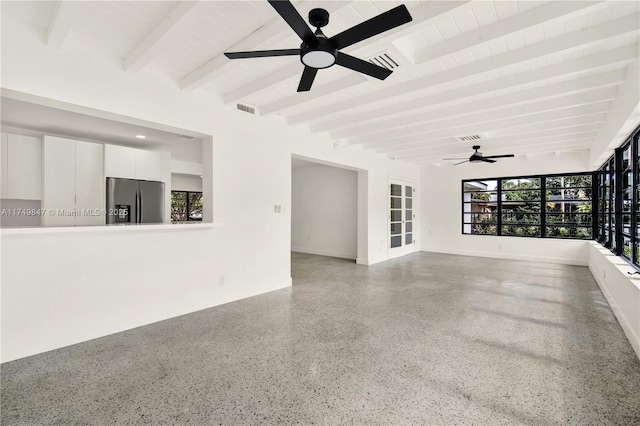 unfurnished living room with visible vents, beamed ceiling, speckled floor, and a ceiling fan