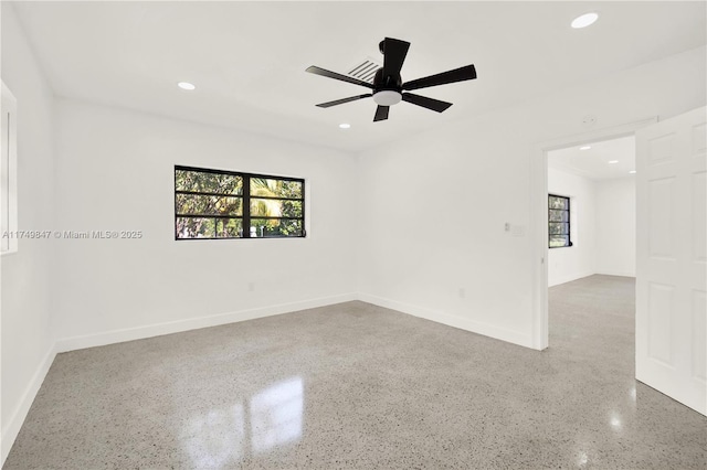 unfurnished room with recessed lighting, baseboards, and plenty of natural light