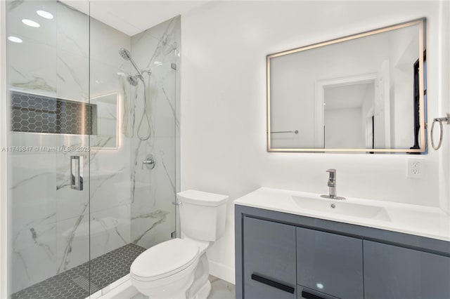 bathroom featuring vanity, toilet, baseboards, and a marble finish shower