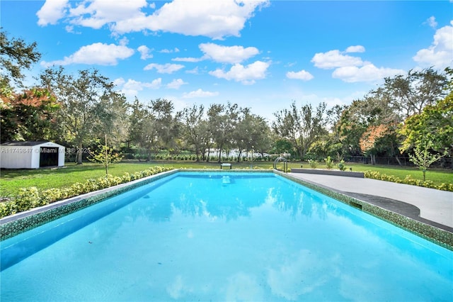 pool featuring an outdoor structure, a lawn, and fence