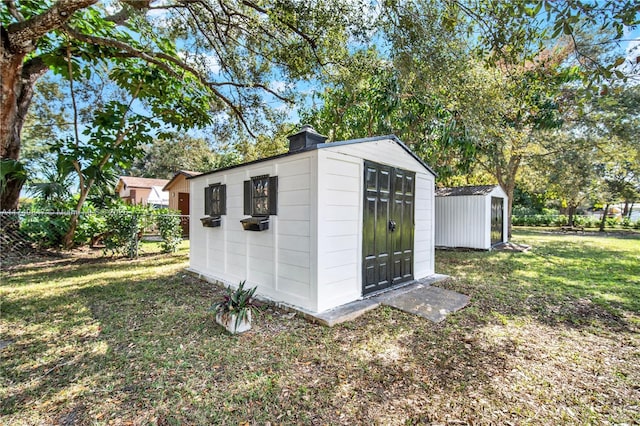 view of shed with fence