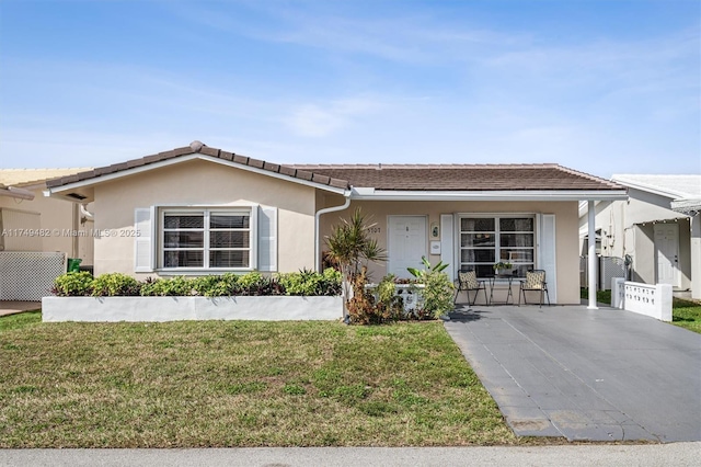 single story home featuring a tile roof, a front lawn, and stucco siding