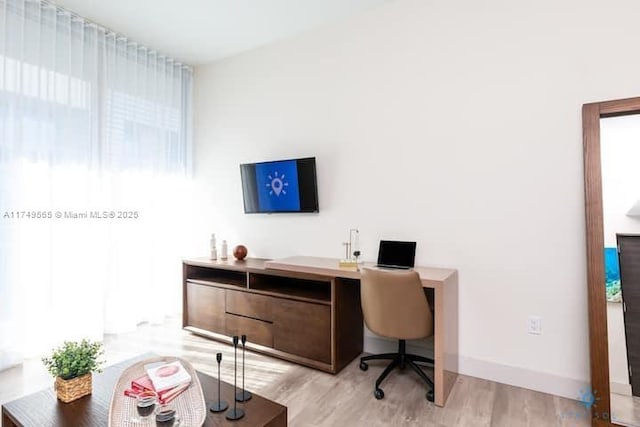 office area with light wood-type flooring and baseboards