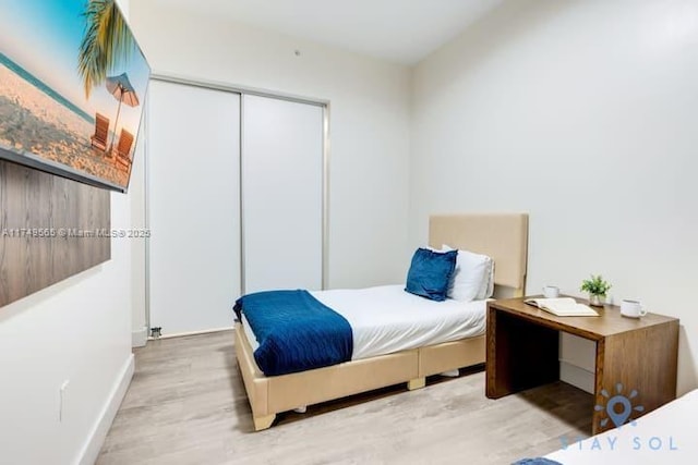 bedroom featuring a closet and wood finished floors