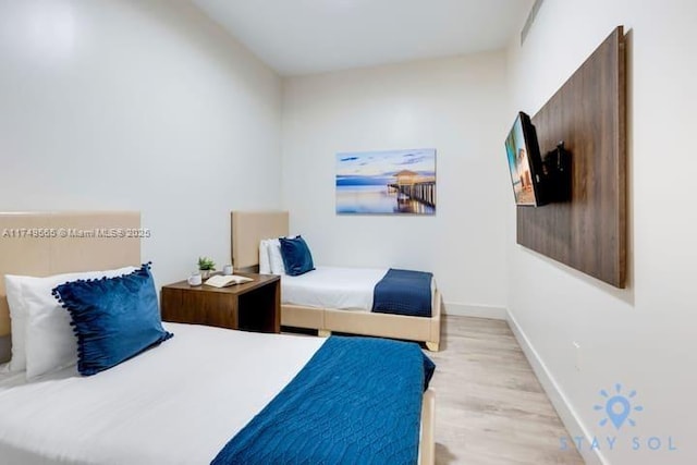 bedroom featuring light wood-style flooring and baseboards