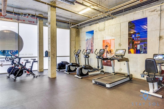 workout area featuring a towering ceiling