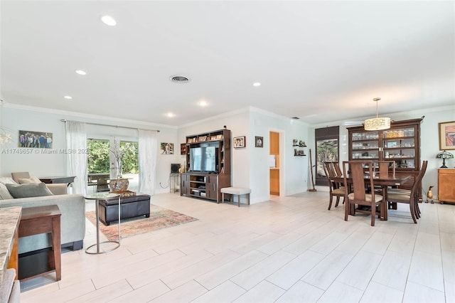 living room with ornamental molding, light wood-type flooring, visible vents, and recessed lighting