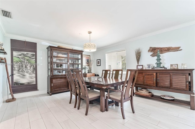 dining room with visible vents and crown molding