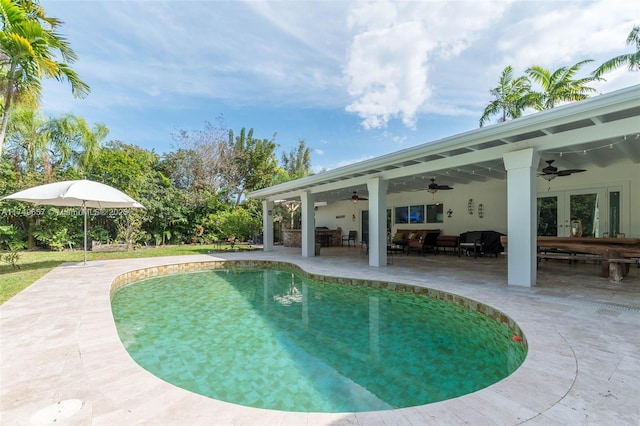 view of swimming pool with ceiling fan, french doors, a patio area, and an outdoor living space