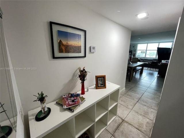 hall featuring light tile patterned flooring