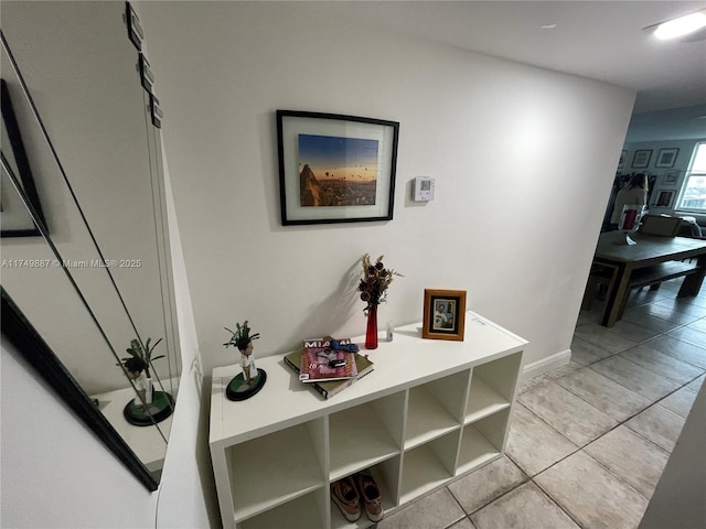 corridor featuring light tile patterned floors