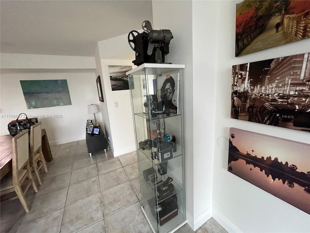 interior space featuring tile patterned flooring and baseboards