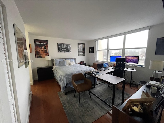 bedroom with wood finished floors and baseboards