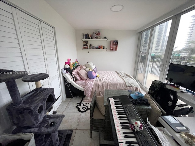 bedroom featuring access to exterior and light tile patterned flooring